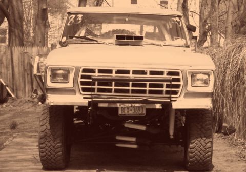 1978 Ford Bronco - This 1978 Ford Bronco features a prominent hood scoop and is lifted with off-road tires, suggesting off-road modifications.