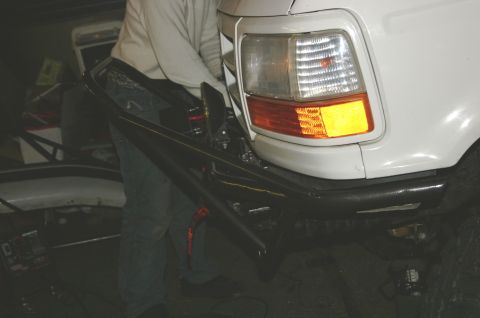1995 Ford Bronco - Close-up of the rear bumper and taillight of a 1995 Ford Bronco during a repair or modification.