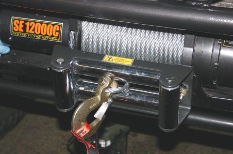 1995 Ford Bronco - Close-up of a winch labeled SE 12000C, a hook and steel cable.