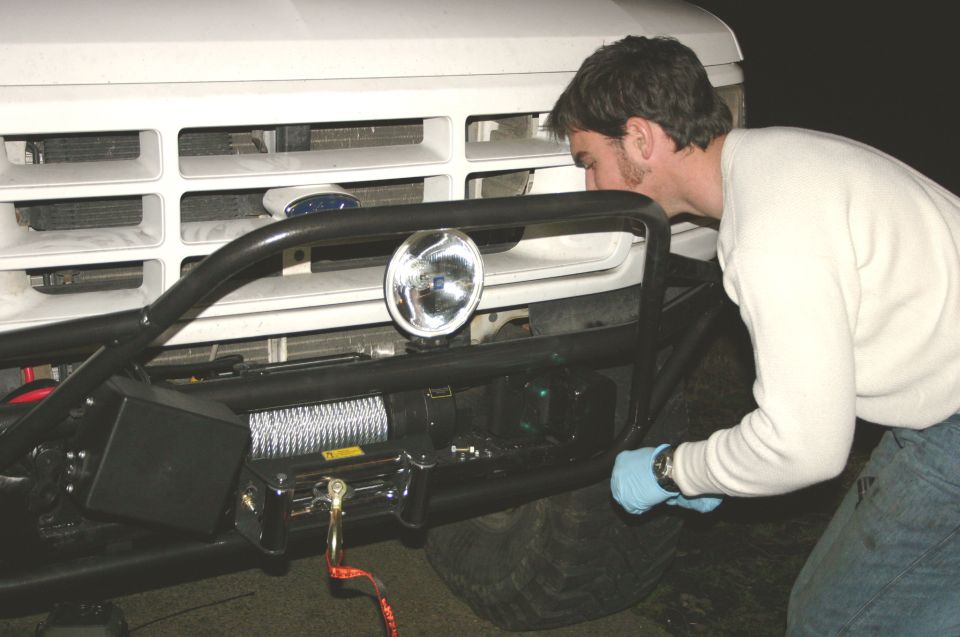 White 1995 Ford Bronco front bumper with winch and light