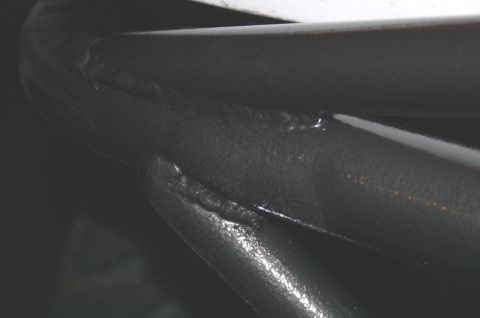 1995 Ford Bronco - Close-up of welded metal bars, showing texture and seams. The SuperMotors logo is visible in the corner.