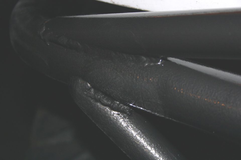 Welded black metal bars with visible seams and texture