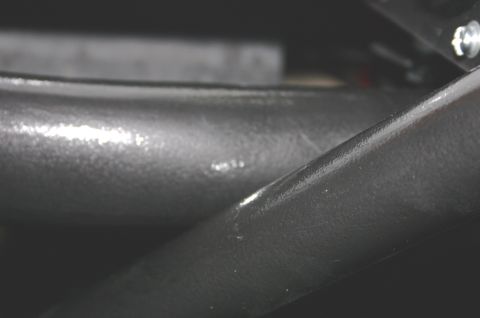 1995 Ford Bronco - Close-up view of a black interior roll bar, showing some wear and tear.