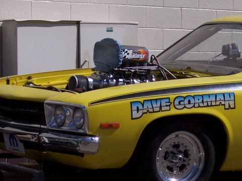 1972 Ford Ranchero - A yellow drag car with a prominent blower and 'Dave Gorman' lettering is shown from the front quarter angle.