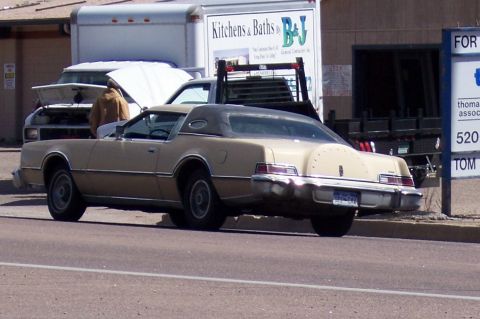 1972 Ford Ranchero - This tan 1977 Lincoln Continental Mark V coupe is seen from the rear, its distinctive vinyl roof and spare tire cover.