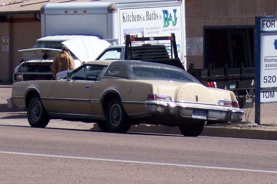 Tan 1977 Lincoln Continental Mark V coupe, rear view. Vinyl roof