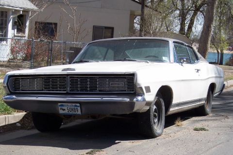 1972 Ford Ranchero - This white 1970 Ford Galaxie is parked curbside, showing its distinctive chrome grille and Colorado license plate.