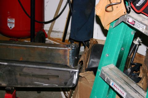 1995 Ford Bronco - Close-up of a chrome rear bumper section, showing welded joints and some surface rust.