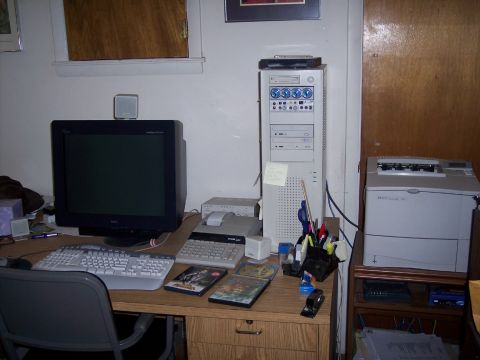 1972 Ford Ranchero - A desk is set up with a computer, monitor, keyboard, calculator, and printer.
