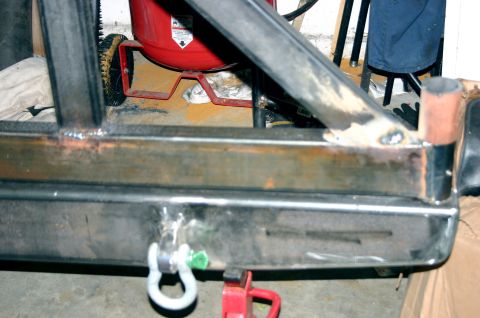 1995 Ford Bronco - A custom rear bumper assembly with a tow hitch and shackle mount is shown, with visible welding and unfinished metal surfaces.