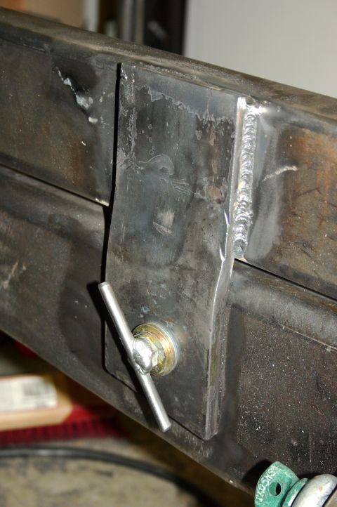 1995 Ford Bronco - Close-up of a metal bracket and bolt assembly on a steel frame.