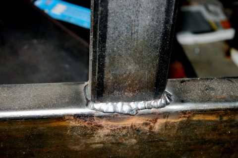 1995 Ford Bronco - A close-up view shows a freshly welded metal seam on a vehicle part.