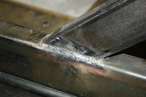 1995 Ford Bronco - Close-up view of a welded metal frame, showing the texture and detail of the welds.