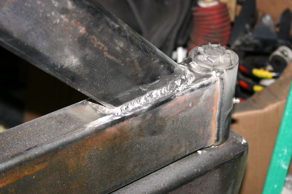 Close-up of welded metal frame part with visible bolt head