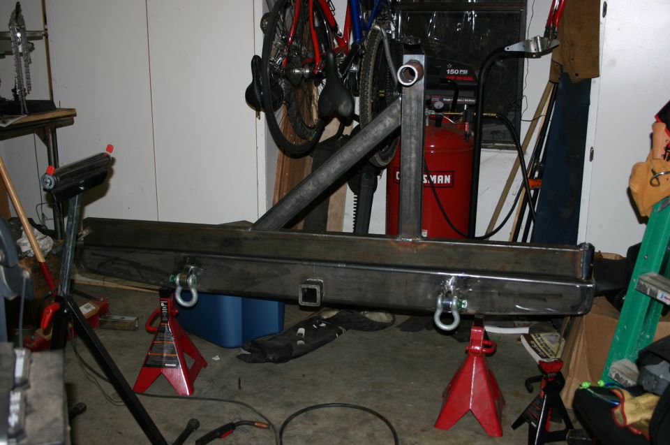 Custom rear bumper with tire carrier mount and tow hitch receiver