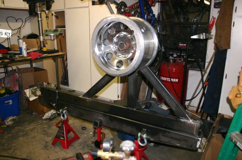1995 Ford Bronco - Custom tire carrier assembly with a chrome wheel is shown in a workshop setting.