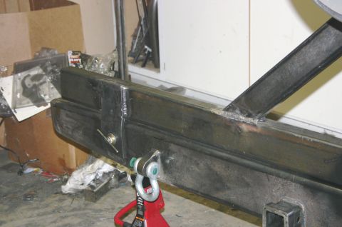 1995 Ford Bronco - Fabricated steel bumper section with tow shackle mount, seen in a garage setting.