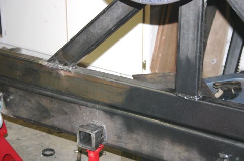 1995 Ford Bronco - Close-up of a custom-fabricated steel bumper section, showing welding and a hitch receiver.