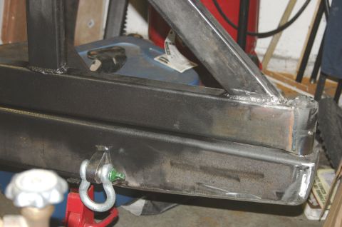 1995 Ford Bronco - Close-up of a metal frame part with a tow hook, possibly for a vehicle bumper or tire carrier.