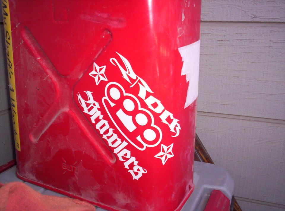Red jerry can with white "Rock Brawlers" and brass knuckles sticker