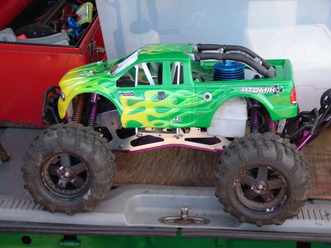 1994 Ford Bronco - RC monster truck with "ATOMIK" branding and flame graphics sits on a surface.