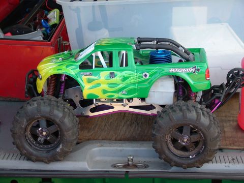1994 Ford Bronco - This remote-controlled truck features a bright green body with flame graphics and prominent F-350 badging.
