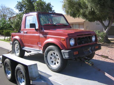 1987 Suzuki Samurai - 1987 Suzuki Samurai being transported on a trailer.