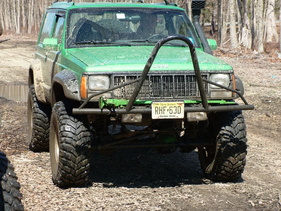 Green Jeep Cherokee with snorkel and bull bar, front view