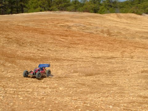 1994 Ford Bronco - Remote control buggy driving on a dirt track with trees in the background.