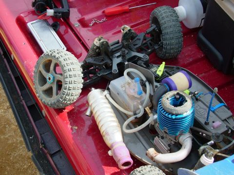 1994 Ford Bronco - Disassembled remote control car engine and components are visible on a red surface.