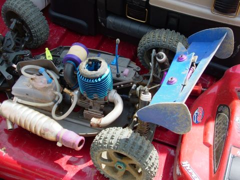 1994 Ford Bronco - Close-up of a remote control car's engine and chassis, showing its components and blue spoiler.