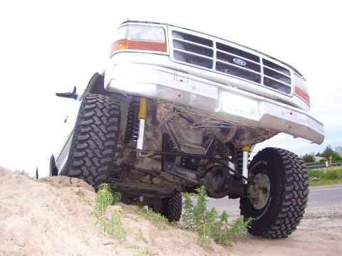 1994 Ford Bronco - Underside view of a lifted 1994 Ford Bronco, highlighting its suspension and off-road tires.