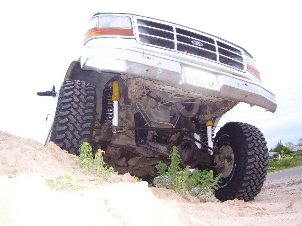 1994 Ford Bronco front underside view showing lifted suspension and large tires