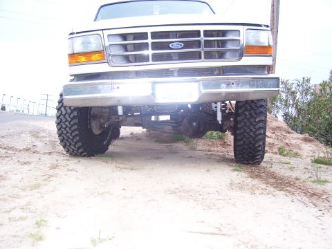 1994 Ford Bronco - Front view of a lifted 1994 Ford Bronco with large off-road tires and a prominent grille.