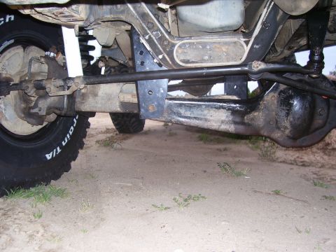 1994 Ford Bronco - Close-up of vehicle undercarriage, focusing on suspension and tires.