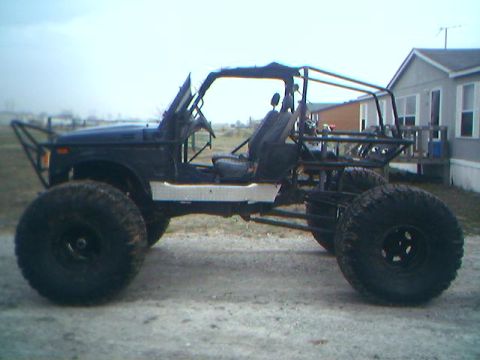 1987 Ford Bronco - This heavily modified buggy features oversized tires and a custom roll cage, suggesting it's built for extreme off-road use.