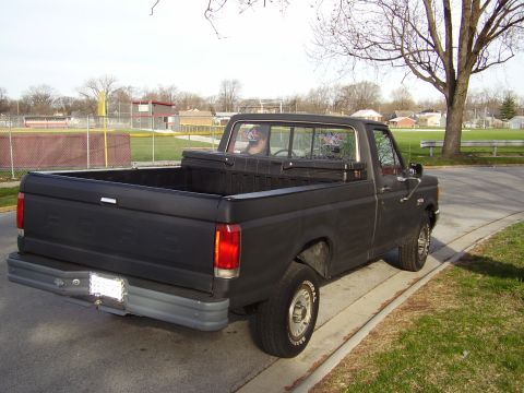 1996 Ford F-150 - This black Ford F-150 pickup truck appears to be from the late 1980s, not a 1996 model.