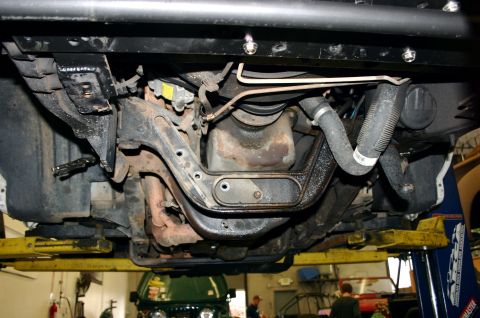 1995 Ford Bronco - Undercarriage view shows suspension and engine components, with another vehicle in the background.