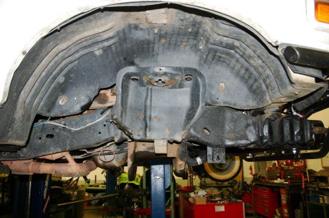 1995 Ford Bronco - This image shows the undercarriage of a vehicle, focusing on the wheel well and suspension system, with a watermark at the bottom.