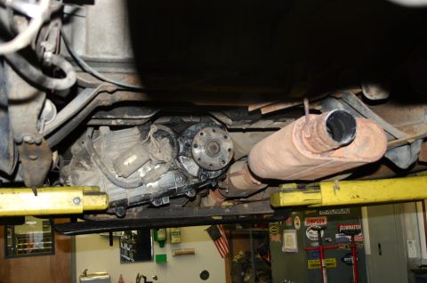 1995 Ford Bronco - Underside view of a vehicle's drivetrain components, including the transmission and exhaust.