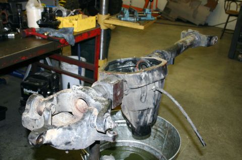 1995 Ford Bronco - Differential housing and axle assembly undergoing maintenance in a workshop.