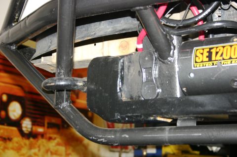 1995 Ford Bronco - Close-up of a SE1200 winch and custom roll cage tubing, likely for an off-road vehicle.