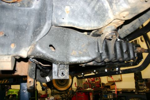 1995 Ford Bronco - The image shows the undercarriage of a vehicle, focusing on suspension components that appear to be Fox Coilovers. Another vehicle is visib…