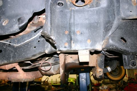 1995 Ford Bronco - Close-up of vehicle frame and suspension components, showing rust and wear.