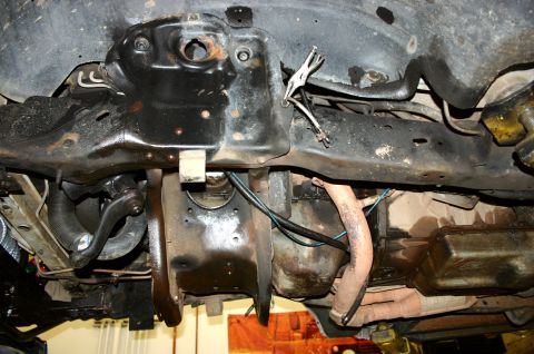 1995 Ford Bronco - The underside of a vehicle shows various mechanical components, including suspension and exhaust systems.