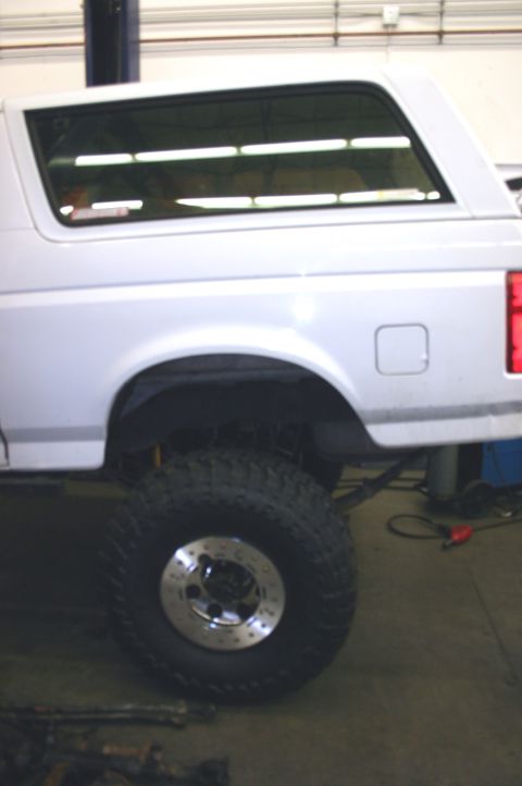 1995 Ford Bronco - This 1995 Ford Bronco features a lifted suspension and large tires, suggesting off-road modifications.