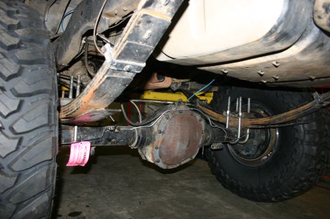 1995 Ford Bronco - Rear axle and suspension components with a pink warning tag attached.