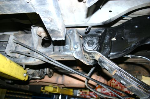 1995 Ford Bronco - Underside view of a vehicle's suspension system, showing various metal components and brake lines.