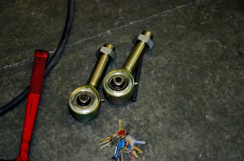1995 Ford Bronco - Suspension components and tools are laid out on a workshop floor.