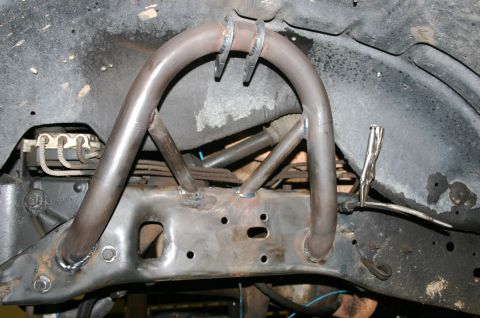 1995 Ford Bronco - Custom suspension components are welded onto a vehicle's frame, obscuring the original vehicle details.